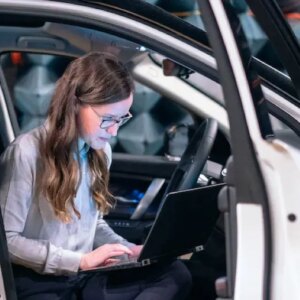 A girl using laptop in a car